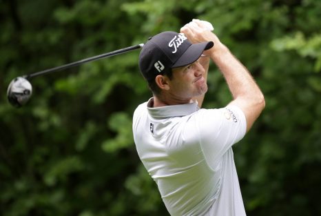 Golf player looks unpleasant with his tee shot during a game