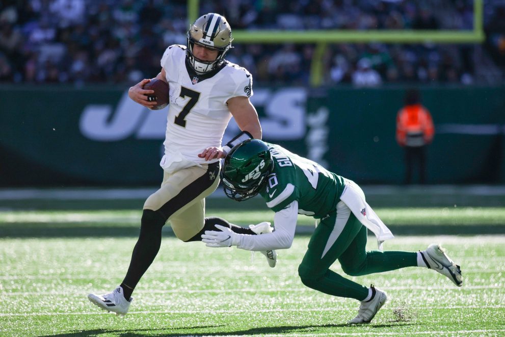 American football players battle for the ball during a game