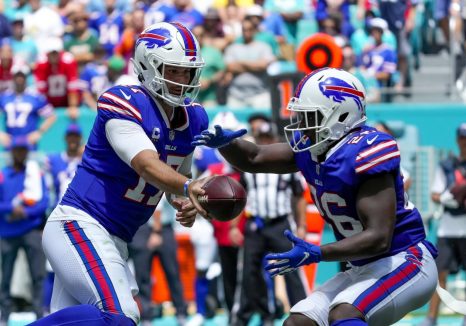 American football player passes the ball during a game