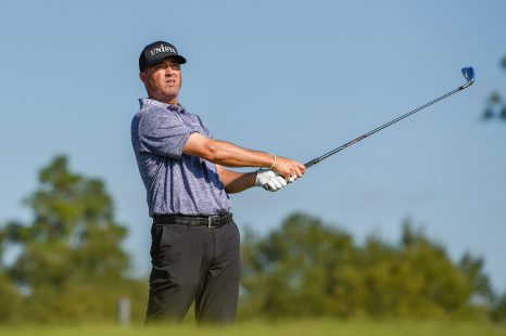 Golf player watches his tee shot during a golf game