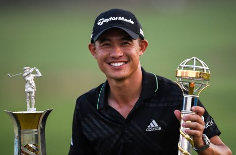 Collin Morikawa is posing with the trophies after winning DP World Tour Championship