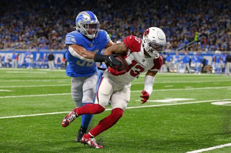 American football player runs the ball during a match