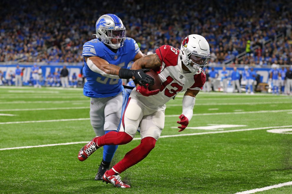 American football player runs the ball during a match