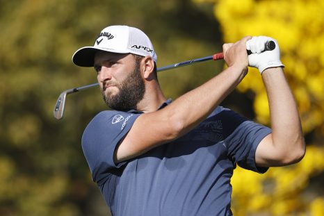 Golf player hits his tee shot at a hole during a game