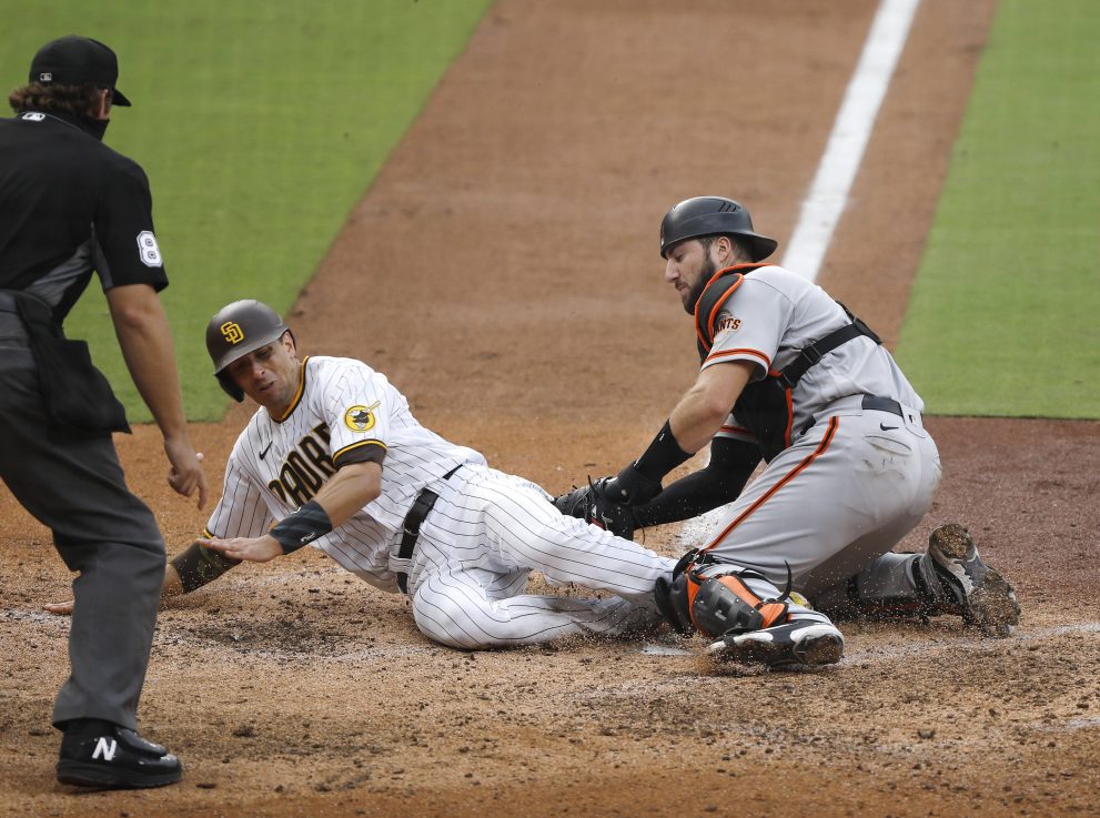 Baseball player is tagged out at the plate during a match