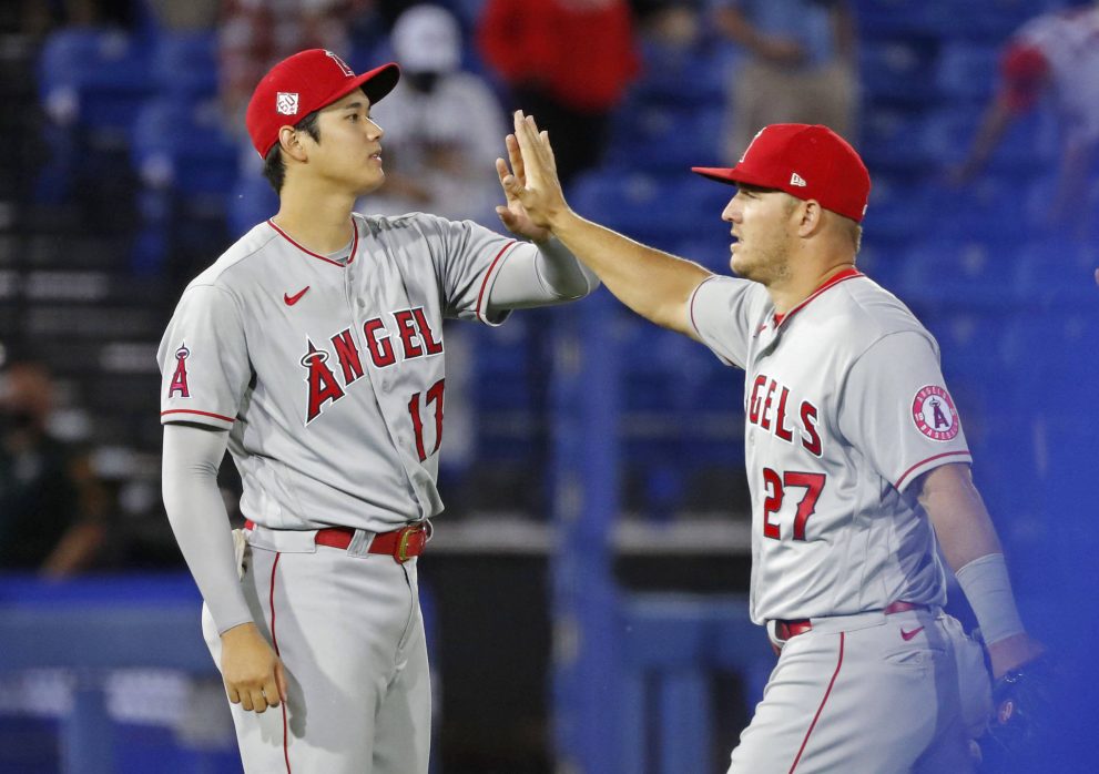 Two baseball players high-five after the game