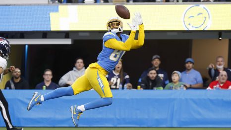 American football player catches the ball during a match