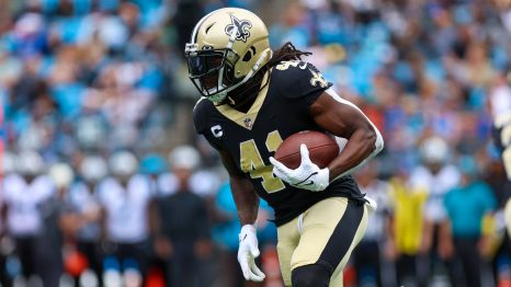 American football player runs to a touch down during a match