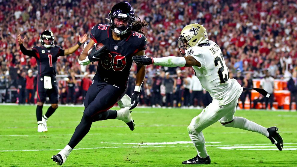 American football player runs to a touch down during a match