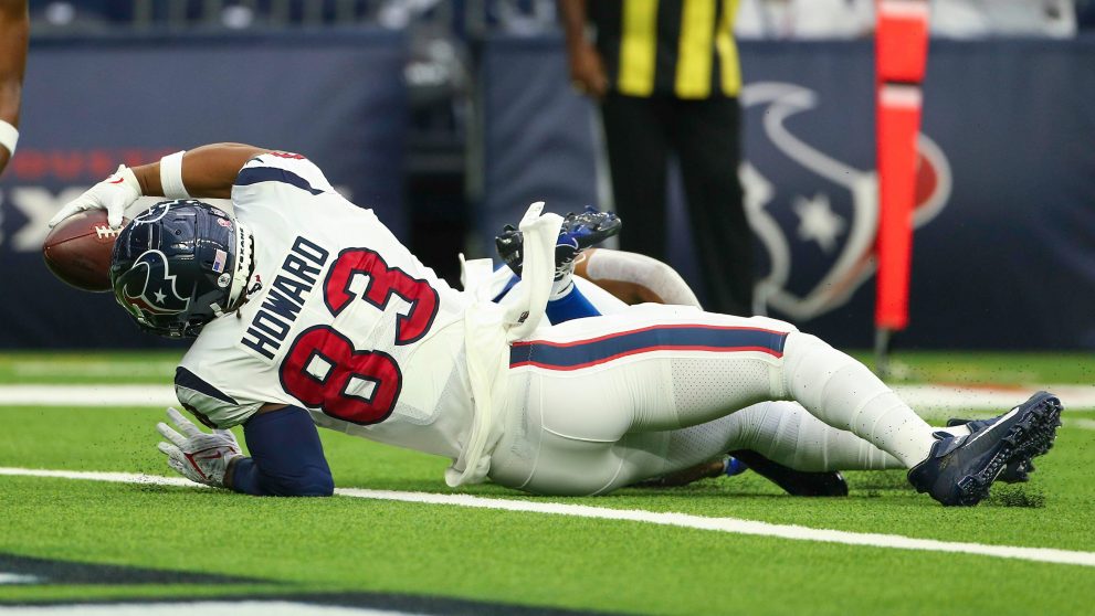 Two American football players fight for a ball during a match